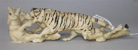 A Japanese carved ivory group of a tiger and two wolves, c.1900, 15cm